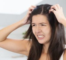 woman scratching scalp