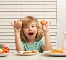 Child eating two eggs for breakfast