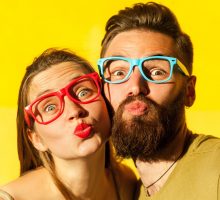 woman and bearded man send air kisses on valentines day