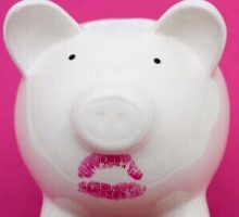 Pink piggy bank wearing red lipstick