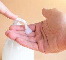 liquid soap squirting on hands for hand-washing