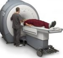 Medical technician about to administer an MRI to a patient.