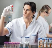 Male technician analyzing blood sample in medical laboratory