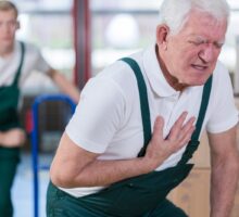 Man clutching chest because of a bad heart attack