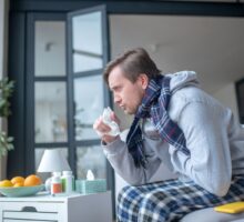 Man in bed with terrible cough and congestions