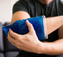 Man icing an injured elbow