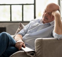 Man napping in chair needs sleep reset