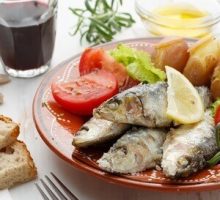 a plate with fish and veggies, typical mediterranean diet