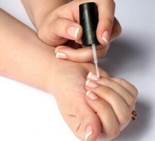 woman applying nail polish