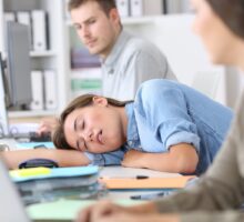 worker fast asleep at desk because of narcolepsy or long COVID