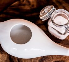 Neti pot with sterile water and salt for rinsing sinuses