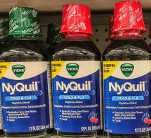 NyQuil bottles stand on a store shelf