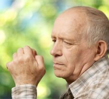 Older man looks down, concerned about Alzheimer disease