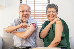 Older people showing off bandages on arms after vaccination. Vaccines and Alzheimer disease