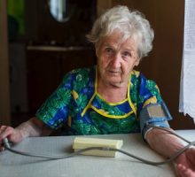 Older woman taking her blood pressure