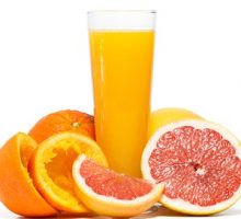 Oranges, grapefruit, and a glass of orange juice