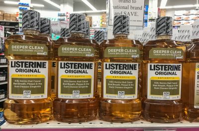 pharmacy shelf with four bottles of original amber Listerine