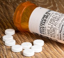 Oxycodone tablets and pill bottle for people in pain