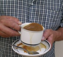 Person with Parkinson's disease spilling coffee from shaking