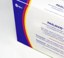 Package of Paxlovid with instructions to take 3 pills morning and evening
