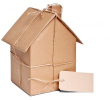 Brown paper sculpture of a house with a label for the home address
