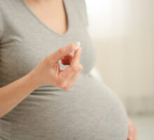 woman taking acetaminophen during pregnancy