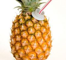 a pineapple with a juice straw sticking out of the top of it