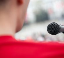 microphone and shoulder of man with fear of public speaking