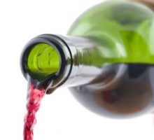red wine pouring out of a wine bottle