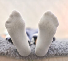 view of soles of feet clad in socks to cover Vicks on feet