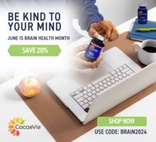 Hand holding CocoaVia Memory + along with apple, coffee, keyboard and CocoaVia Memory & Focus for Brain Health Awareness Month