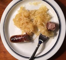 a plate of sauerkraut and sausage