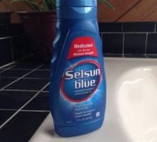A bottle of Selsun Blue dandruff shampoo to ease eczema, under-breast rash with dandruff shampoo