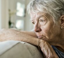 older woman looking pensive and depressed