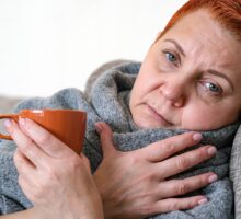Woman is lying on sofa sick with influenza (flu)