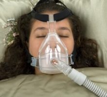 anti-snoring device, sleeping woman with CPAP machine on nose and mouth