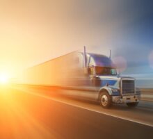truck on highway with sun coming up