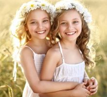 Portrait Of Two Little Girls Twins in a field