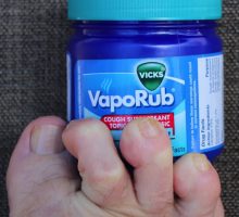 A bottle of vicks vaporub and toes