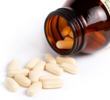 Vitamin C tablets in and out of a bottle