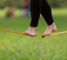 Woman walking a tightrope or a slackline