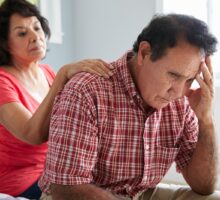 wife comforting husband with memory problems and dementia