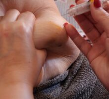 woman is injecting a medication for weight loss