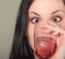woman drinking from a glass trying to stop hiccups