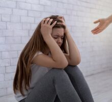 A helping hand reaching out to a woman with anxiety