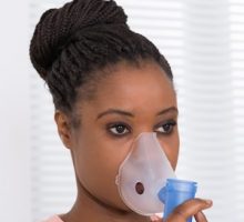 Close-up Of Young African Woman Using Oxygen Mask for cluster headache