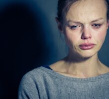 Young woman in distress from mental illness, depression and/or withdrawal