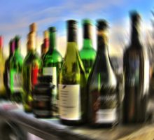 a blurry photo of bottles of wine an alcohol