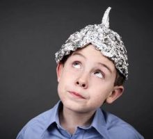Boy in a tin foil hat looking up