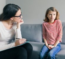 Psychologist evaluating young girl for autism spectrum disorder